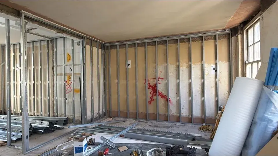Plywood-lined room on metal frame